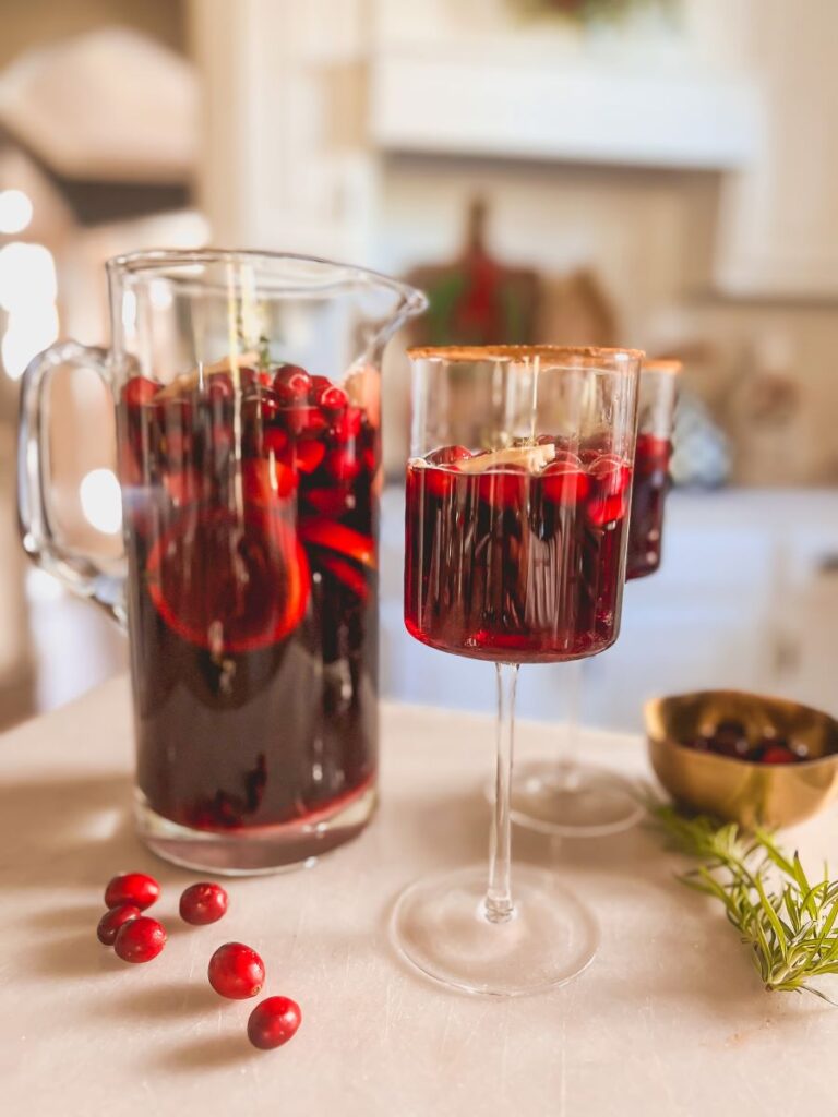 Holiday Sangria Pitcher with long-stemmed wine glasses