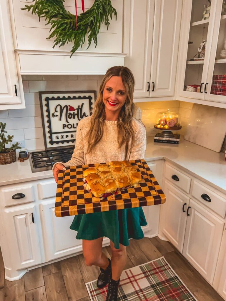 Leanna holding checkered board with turkey sliders