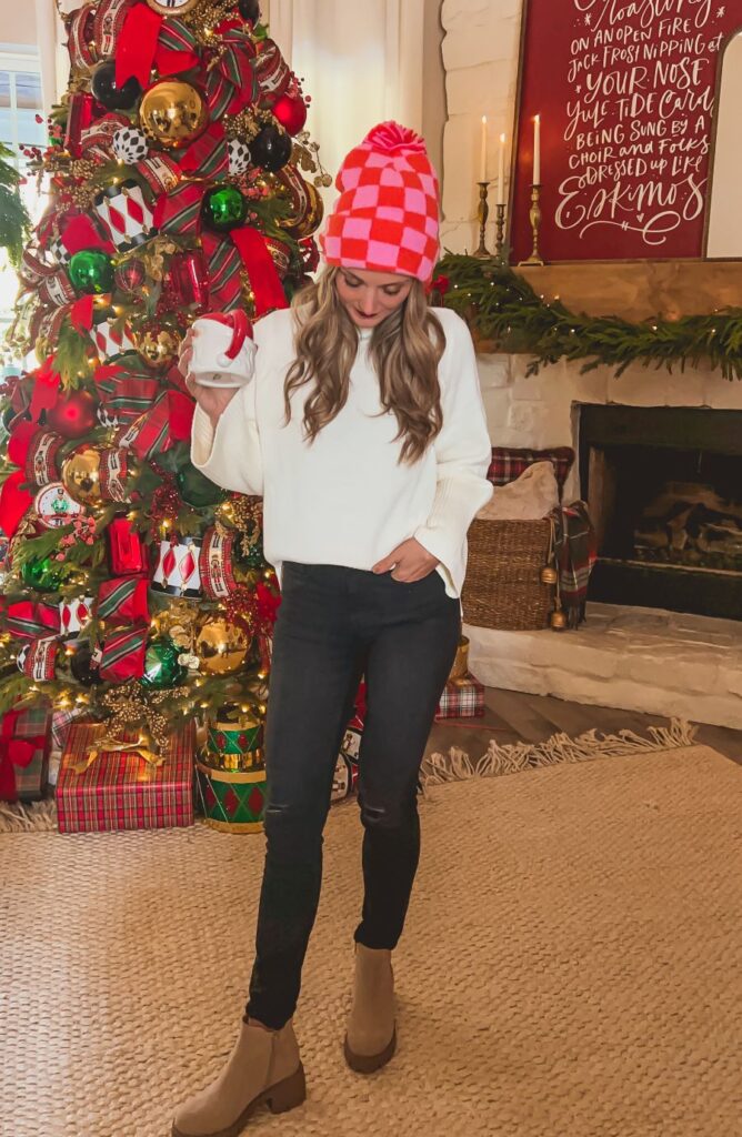 Winter fashion with white sweater, black pants, and brown boots