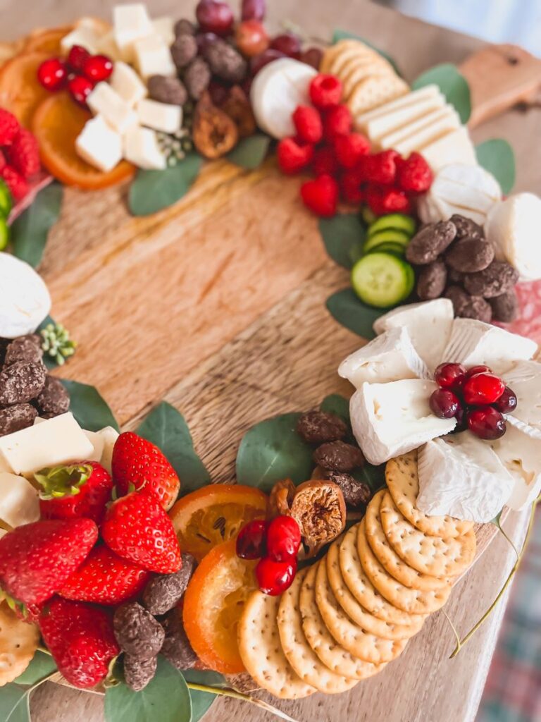 Close-up of charcuterie wreath with fruit, meat, cheeses, and crackers