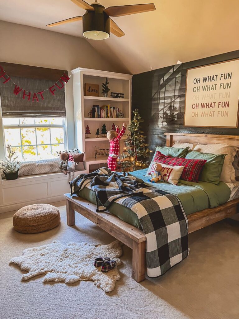 Little boy in a bedroom decorated for the holidays