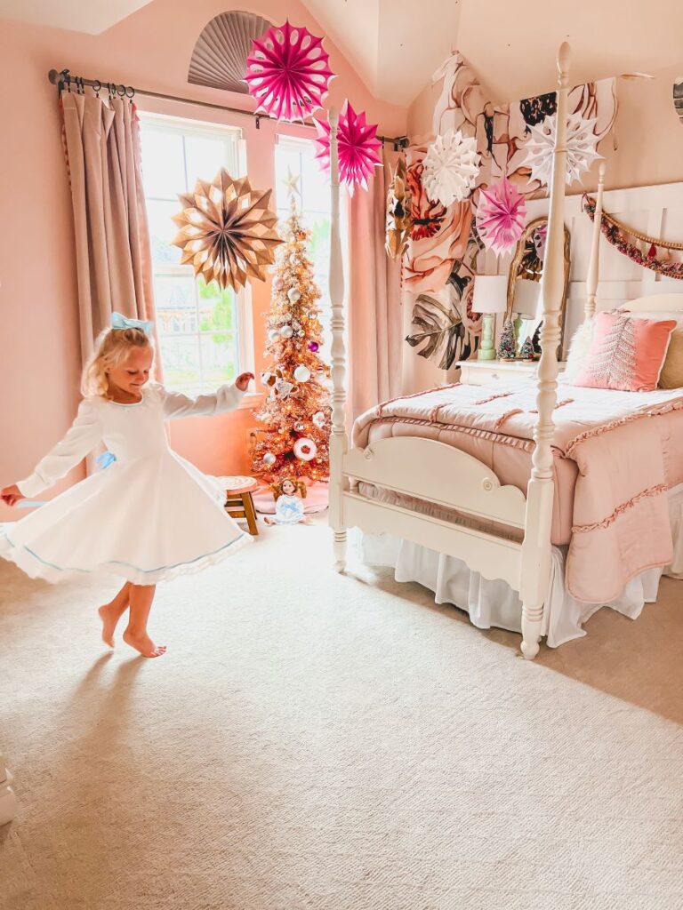 Child spinning in front of Christmas tree