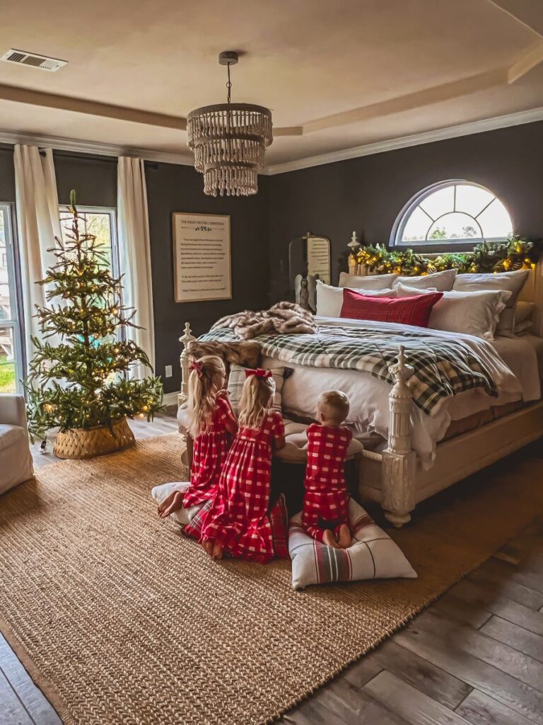 Children praying in front of a beautifully decorated Christmas bedroom