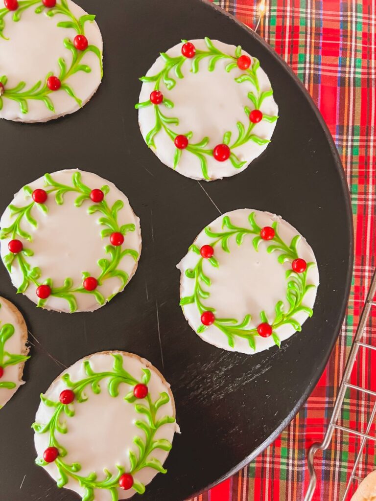 Christmas wreath cookies on a black serving board