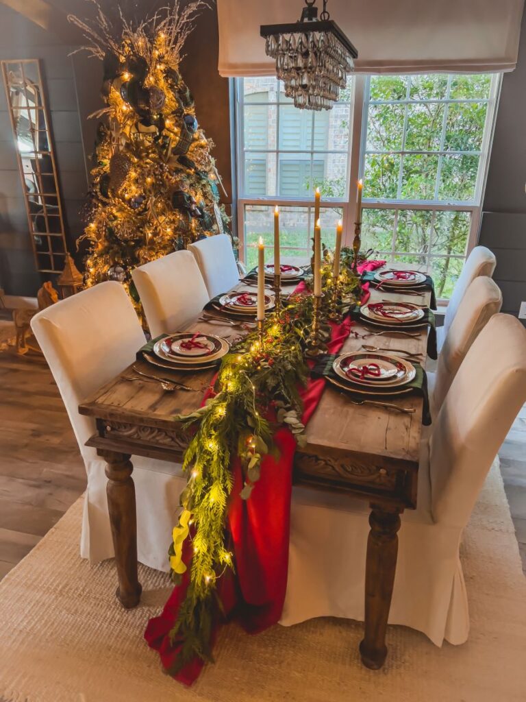 Christmas table with plaid plates in front of a Christmas Tree