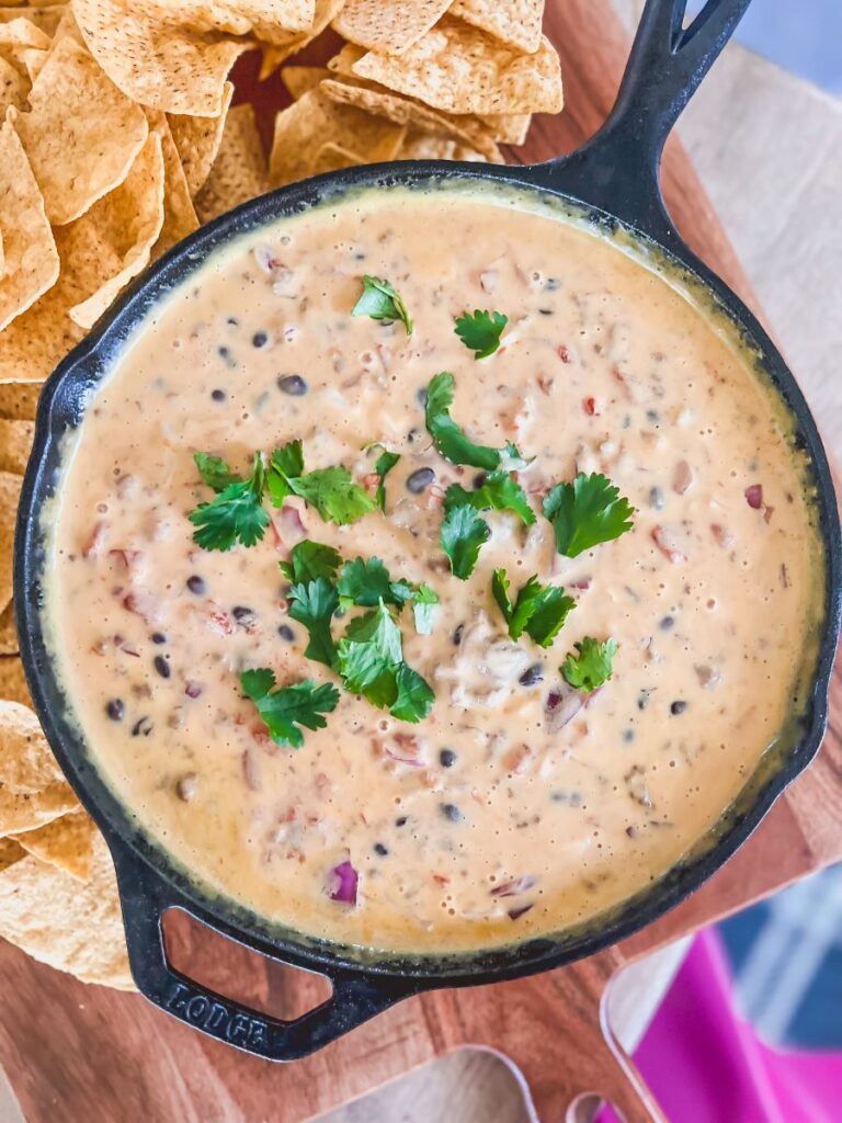 Loaded queso beer dip in cast-iron skillet