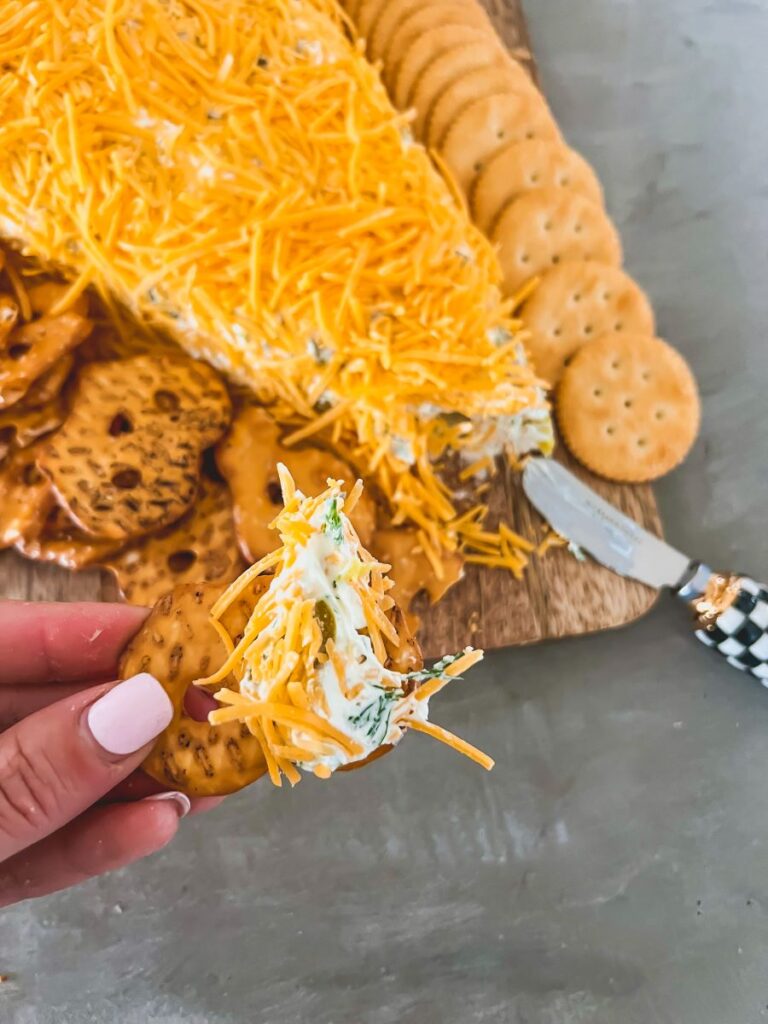 Portion of Carrot-Shaped Cheeseball on wooden serving board