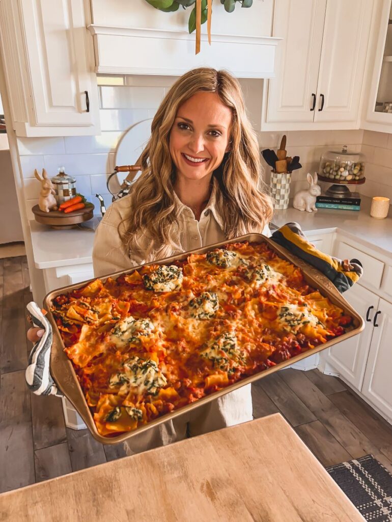 Leanna holding a finished sheet pan lasagna recipe