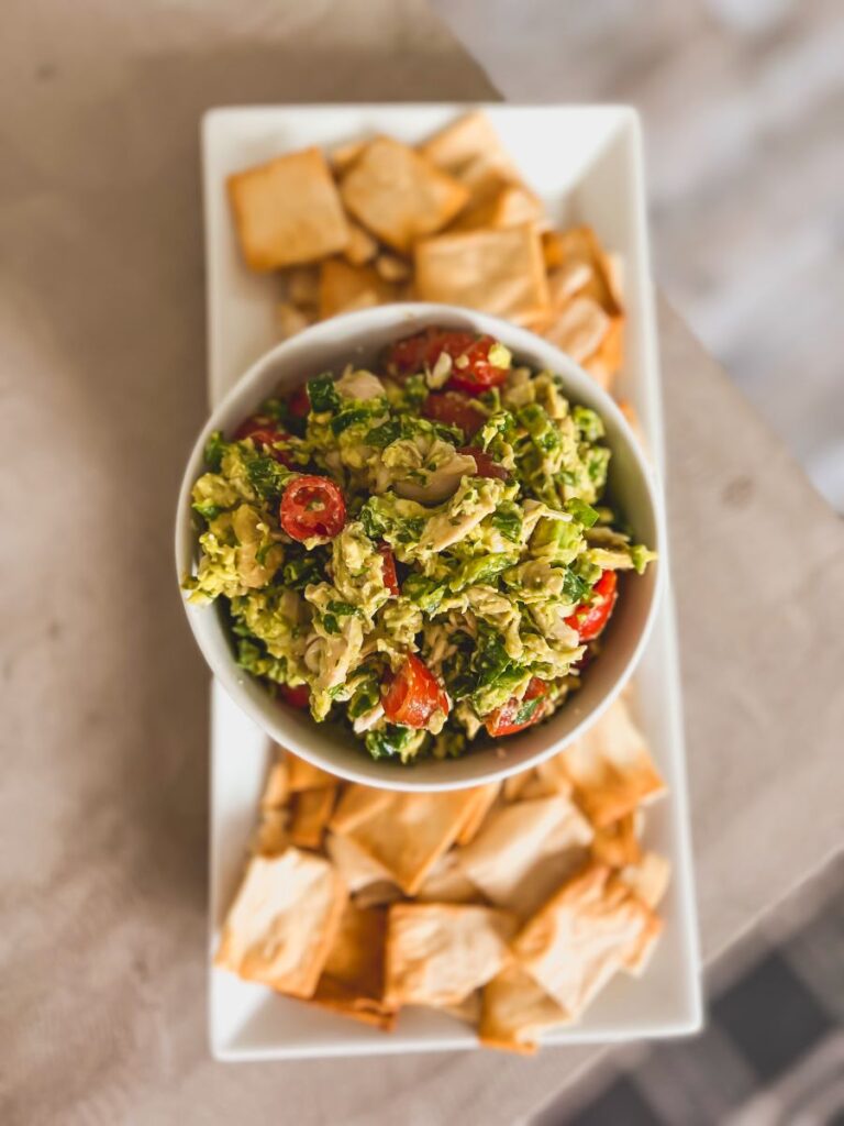 Delicious bowl of Guacamole Chicken Salad on a white serving platter