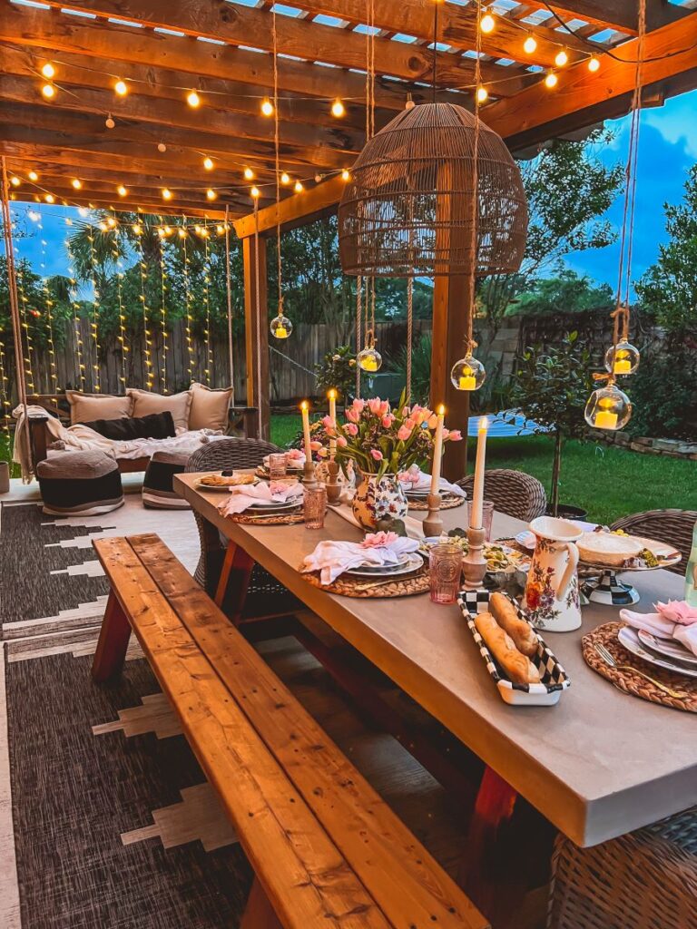 Hanging candles cast a soft glow during a garden party