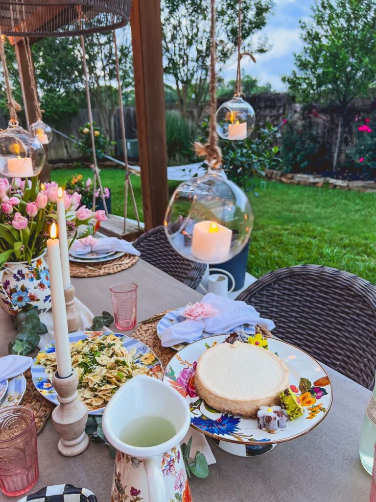 Hanging globe candles over a pretty outdoor tablescape