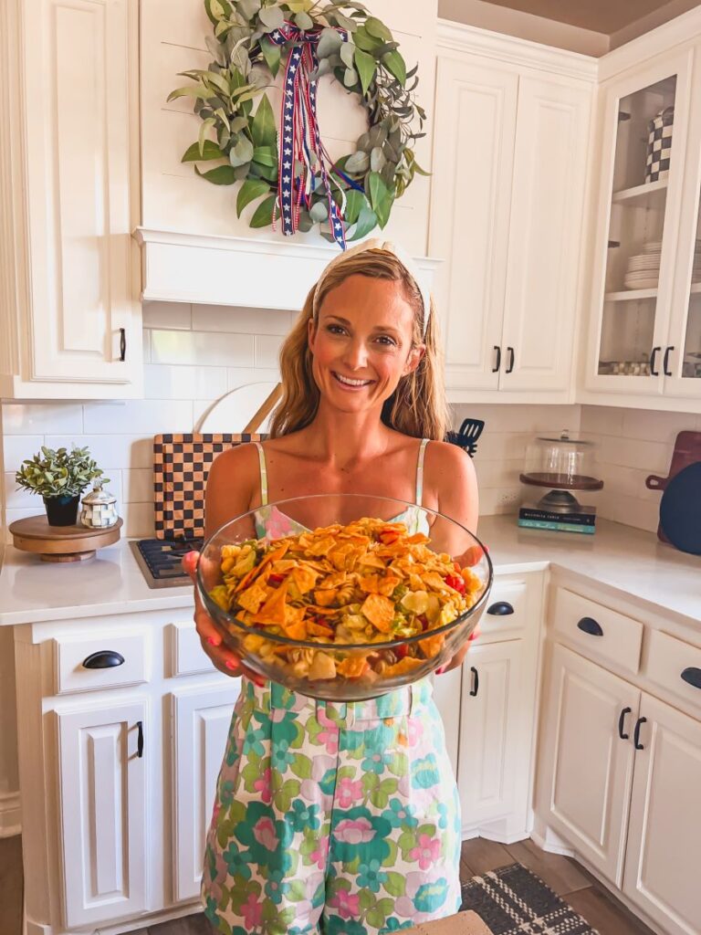 Leanna holding a bowl of Taco Pasta Salad in a clear bowl