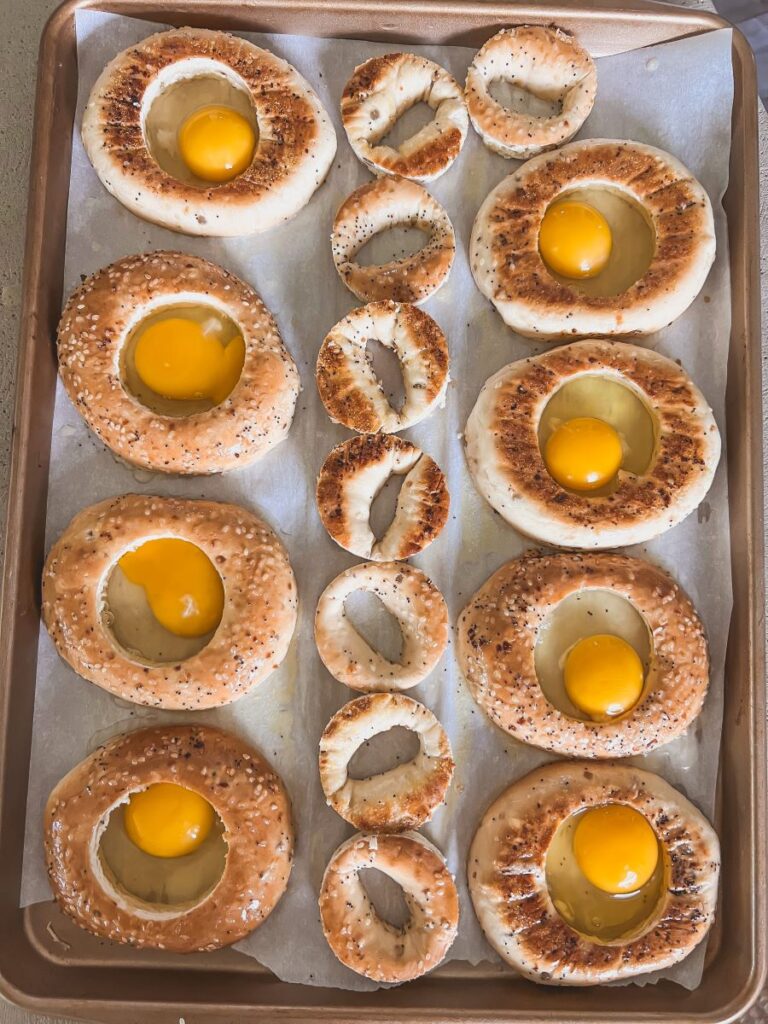 Bagel circles with eggs cracked in the middle
