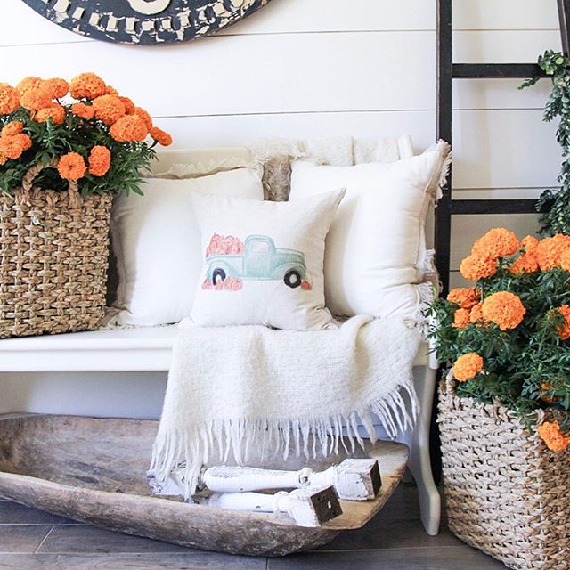 Cozy fall pillow on a white bench