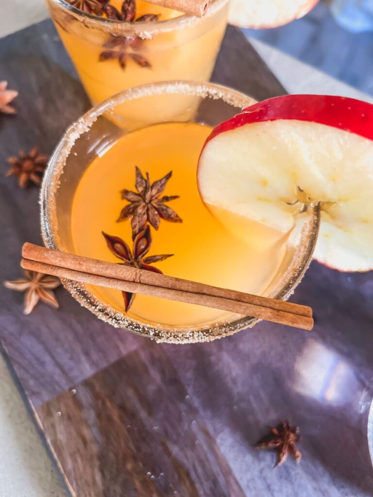 Apple Cider Margarita with an apple garnish and cinnamon stick