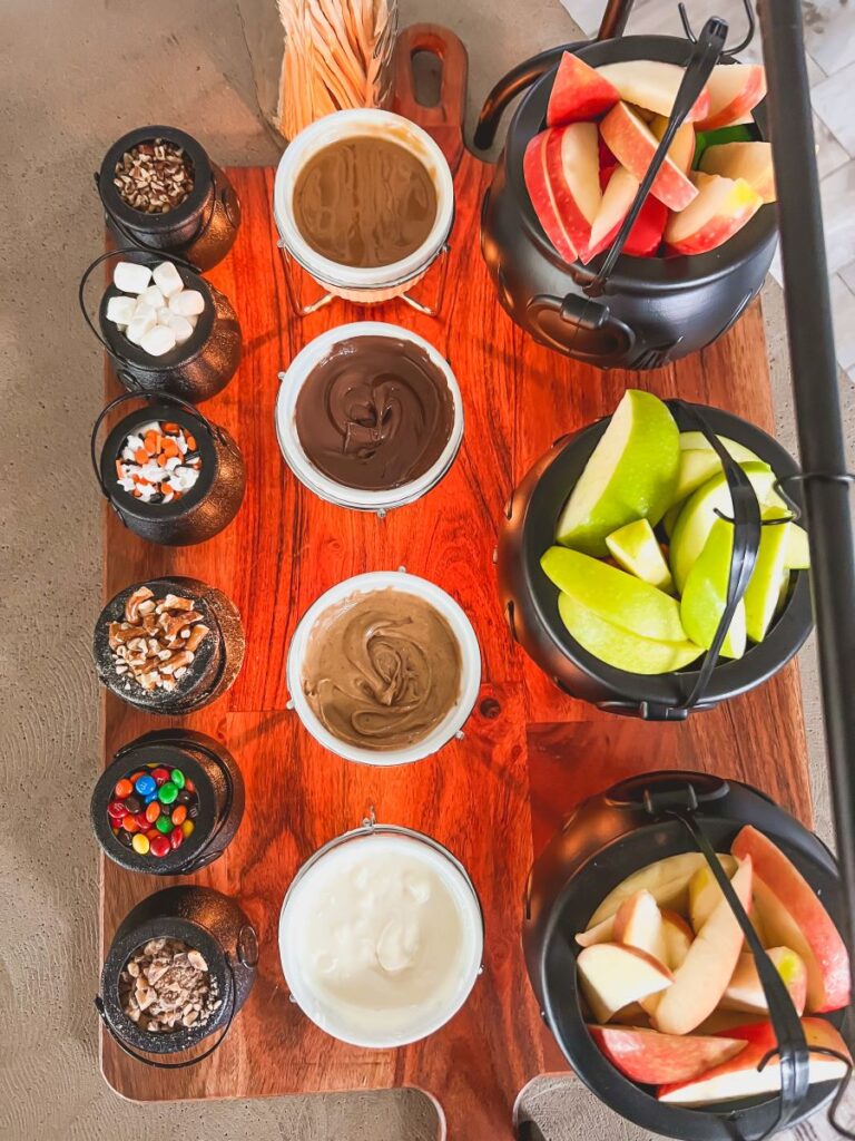 Aerial view of Apples, Sauces, and toppings on a wooden food board