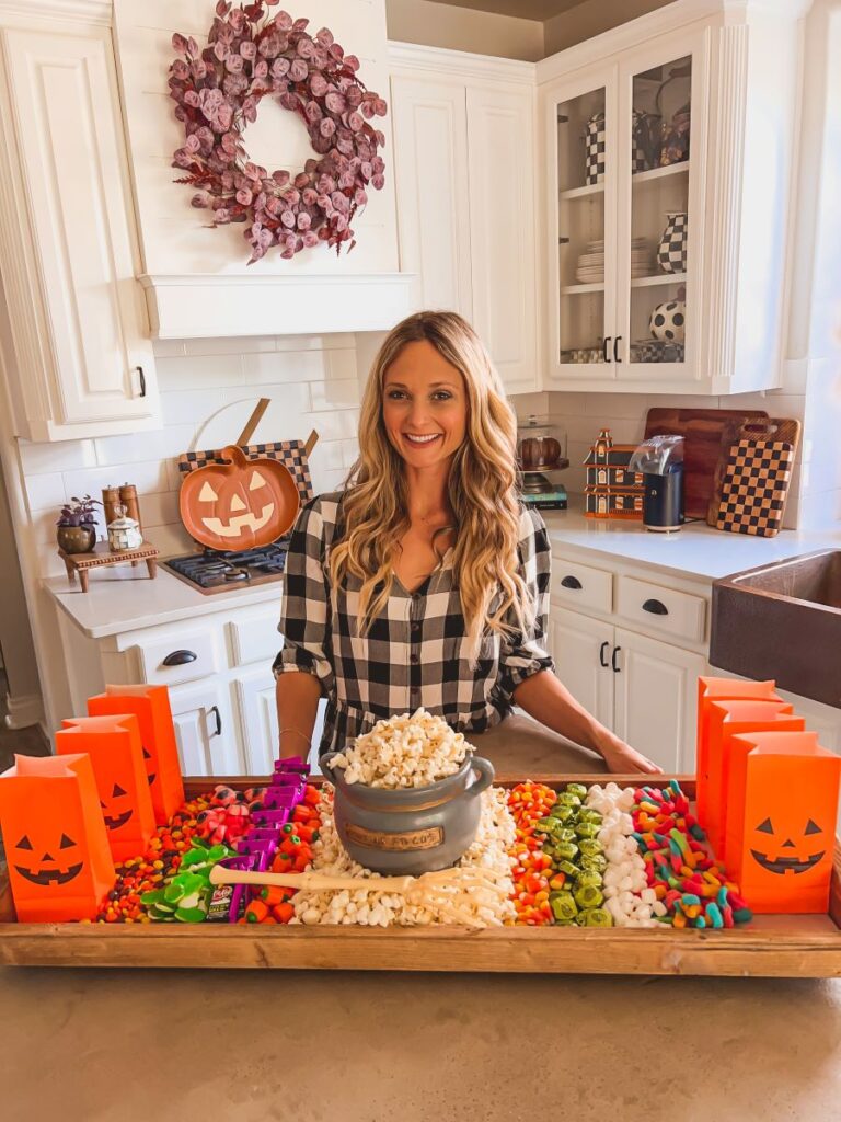 Leanna in front of a Halloween Movie Night Board 