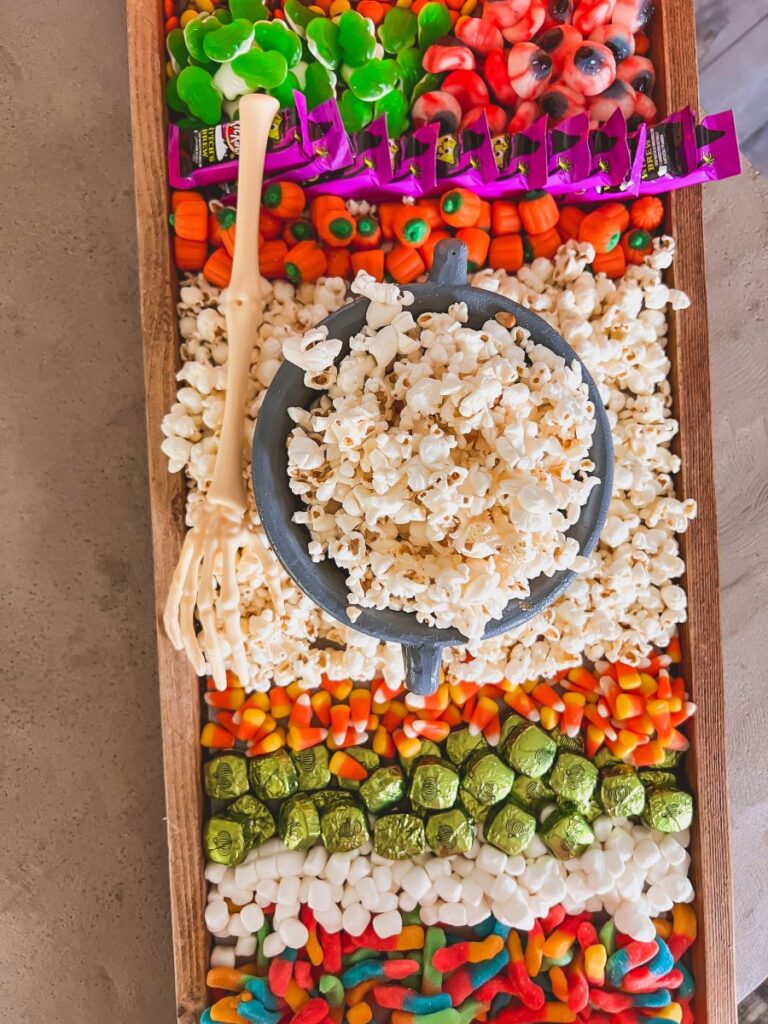 Candy and popcorn on a wooden movie board