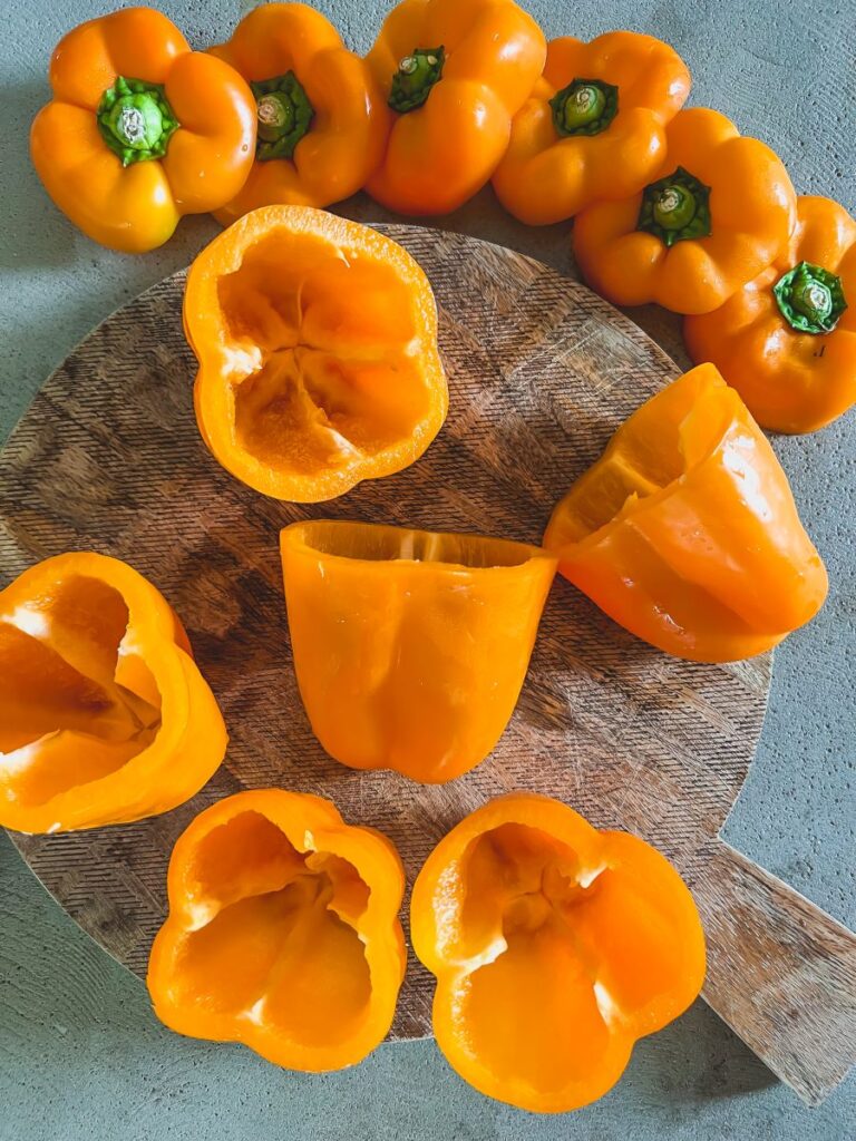 Orange Bell Peppers on a wooden cutting board