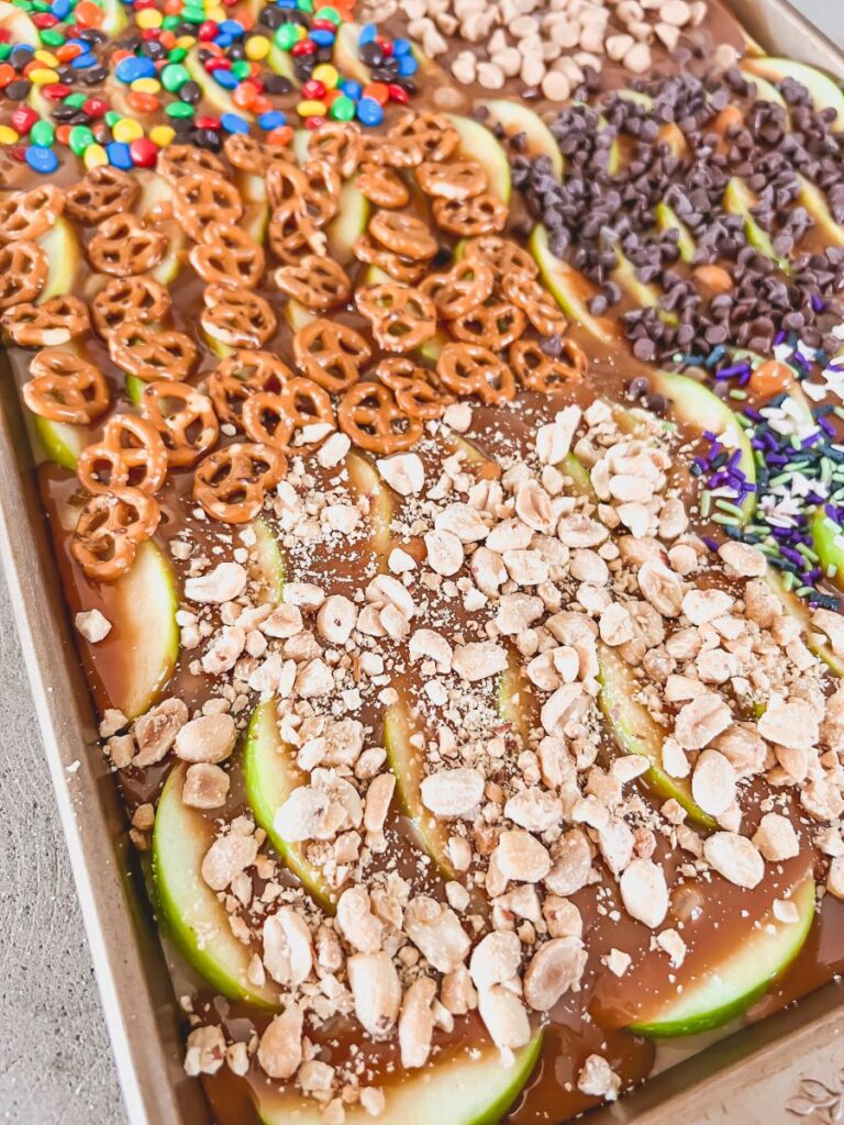 Candy toppings over caramel apples