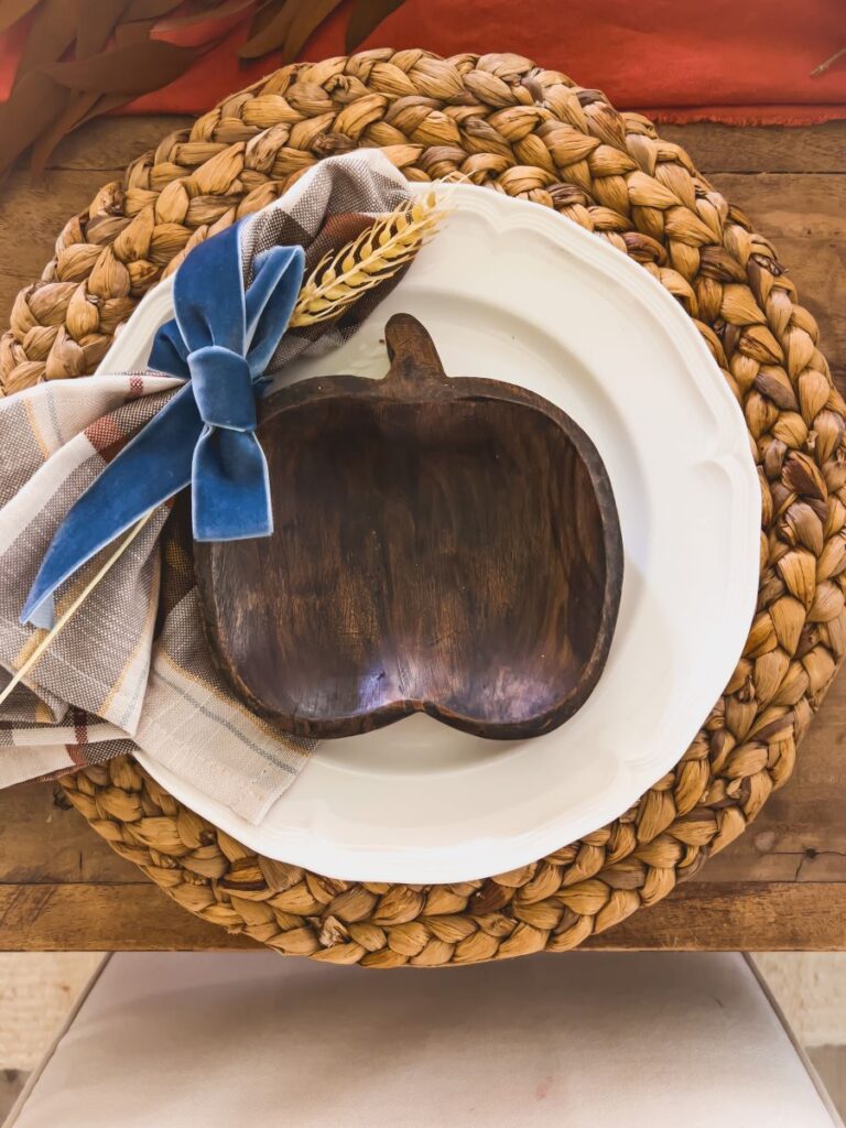 Fall Place setting with a plaid napkin and wooden pumpkin