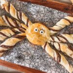 Puff Pastry Spider on a parchment paper with a spider web design