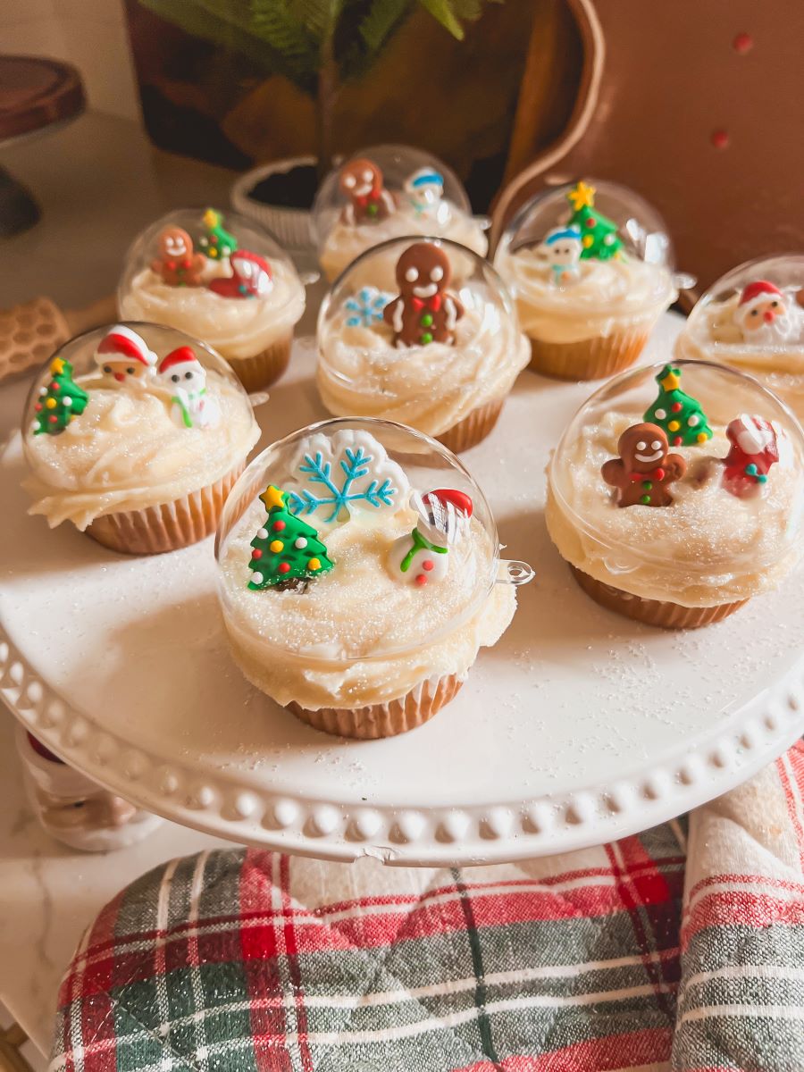Close-up of snow globe cupcakes decorated with sugar Christmas trees