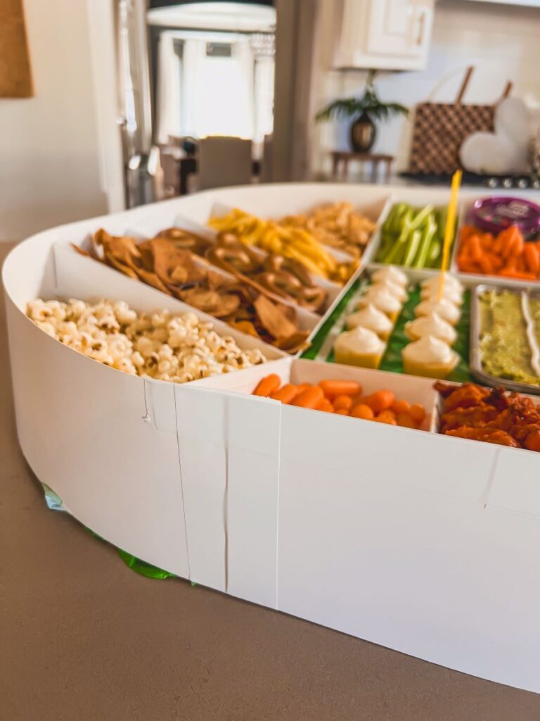 Back of stadium assembled from trays and filled with snacks