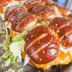 Big Mac Pretzel Sliders on a baking sheet