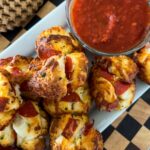 Pizza Muffins next to a bowl of Marinara sauce