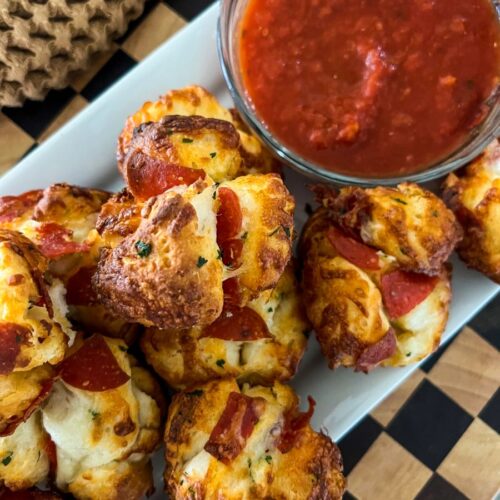 Pizza Muffins next to a bowl of Marinara sauce