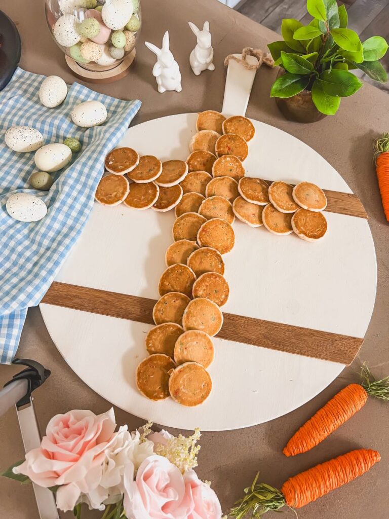 Pancakes in the shape of a cross on a wooden serving board