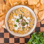 mexican street corn dip in a serving tray with chips