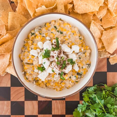 mexican street corn dip in a serving tray with chips