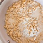 Pasta and chicken dinner in a white frying pan