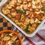 Close-up of Boursin and Tomato Tortellini in a white baking dish