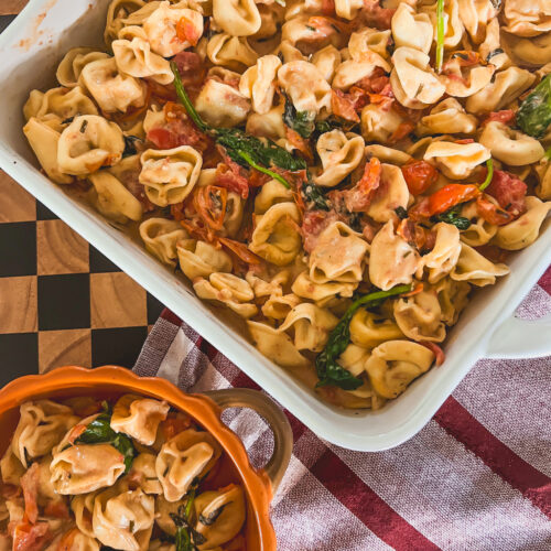 Close-up of Boursin and Tomato Tortellini in a white baking dish