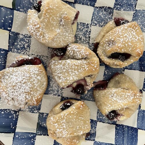 Blueberry Cheesecake Croissants on a blue and white checkered plate