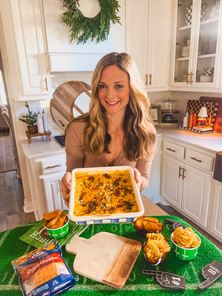 Leanna holding a serving of Loaded Baked Potato Dip