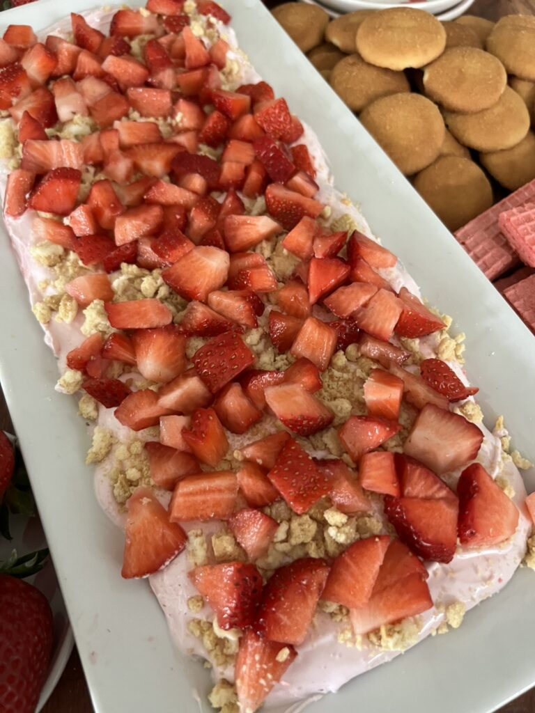 Strawberry shortcake dip covered with strawberries