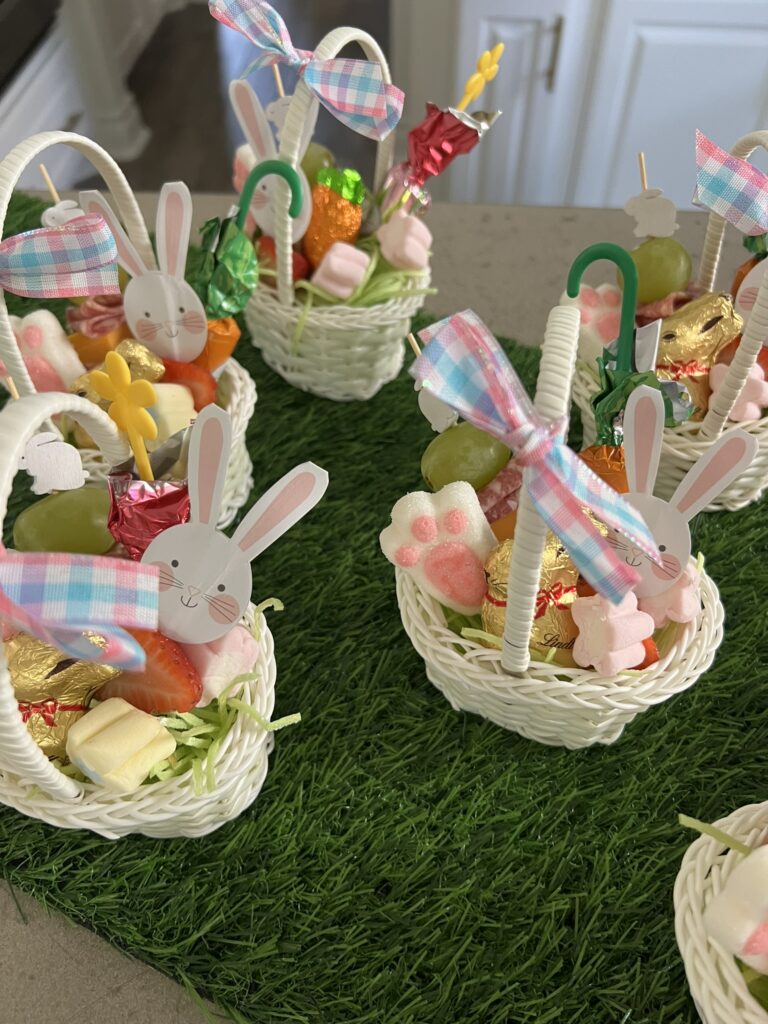 Small white wicker Easter baskets filled with goodies
