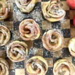 Checkered serving board coverd with Apply Pastry Roses dusted with powdered sugar