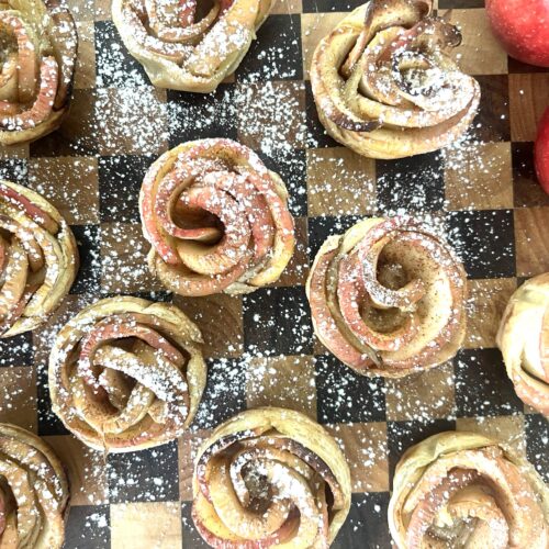 Checkered serving board coverd with Apply Pastry Roses dusted with powdered sugar