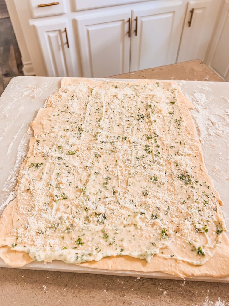 butter mixture spread on crescent dough