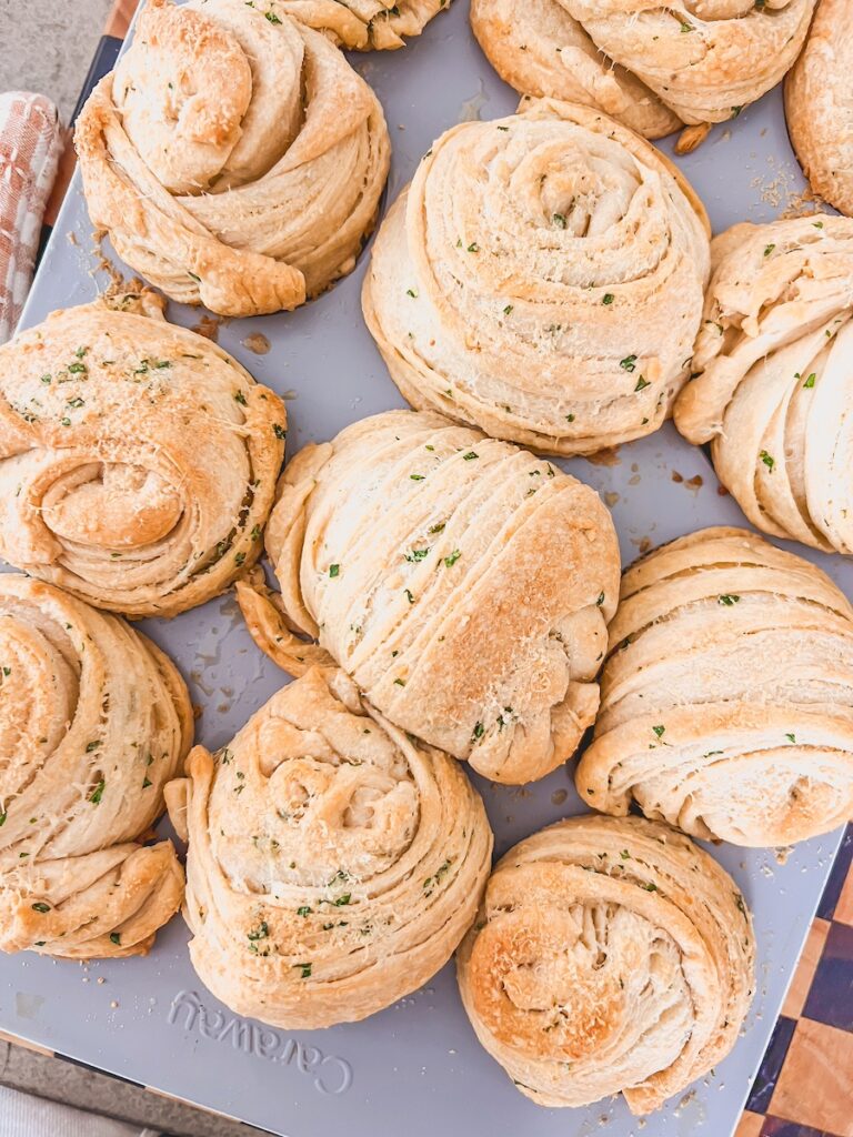 freshly baked garlic parmesan cruffins in muffin tin
