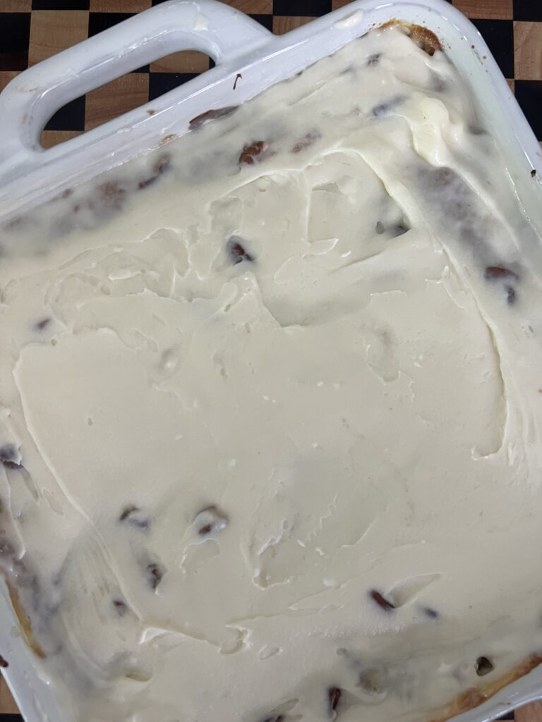 Melted cream cheese and pecans on an Easter Carrot Cake