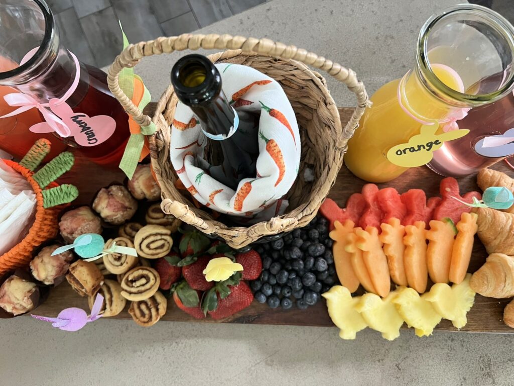 Champagne bottle in an Easter basket for a Mimosa Brunch Board
