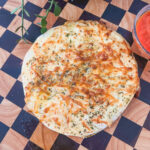 Cheesy Garlic Pizza Bread on a checkered serving board