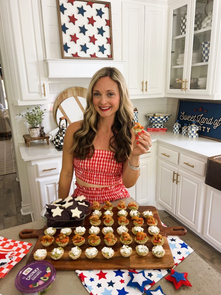 Leanna in front of a patriotic appetizer in a sunny white kitchen