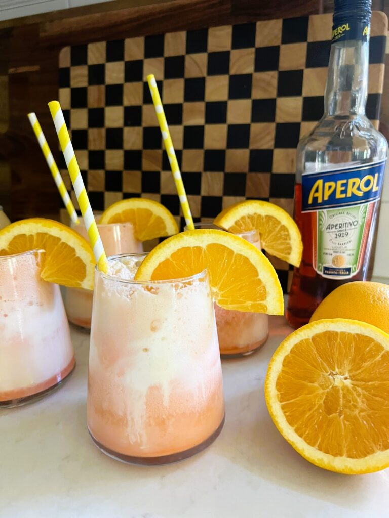 Aperol Floats with orange wedges and orange straws